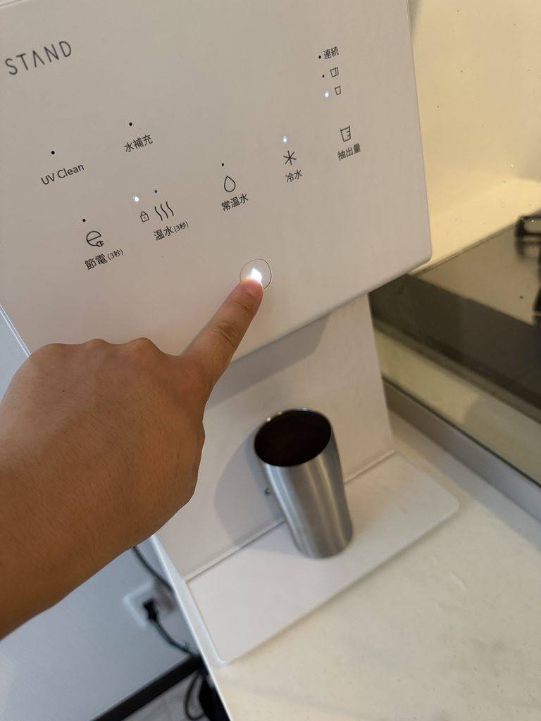 ピュアライフSのボタンを押して冷水を出している様子
